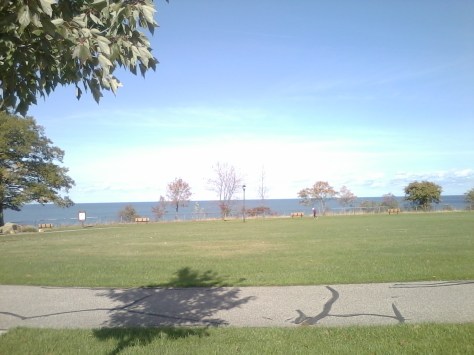 My friends and I walk on Sunday morning on this course. It is a figure eight that is a half a mile long. Then we go to breakfast.  You can see Lake Erie as the deeeper blue behind the green grass. I had to use my camera phone so it isn't the best but it is so peaceful walking and looking out onto the lake and boats, kayaks, And watching the waves. Photograph taken and copyrighted 2013