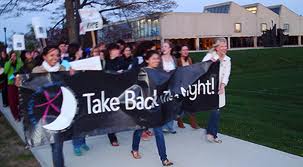 Young women marching to :take back the night:
