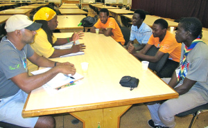 Scott Johnson (in yellow, left) talks to a group of Grenadian Boy Scouts at last year's 