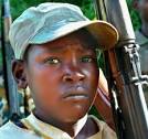 A child soldier who looks terrified.