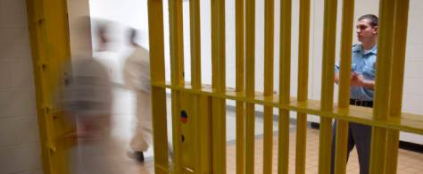 Corrections officer Travis Conklin, right, looks on as prisoners move through the state prison Thursday, March 3, 2011 in Jackson, Ga. Conservative legislators who once heralded strict three-strikes laws and other tough measures that led to bloated prisons are now considering what was once deemed unthinkable: Reducing sentences for some drug and non-violent offenders. (AP Photo/David Goldman)