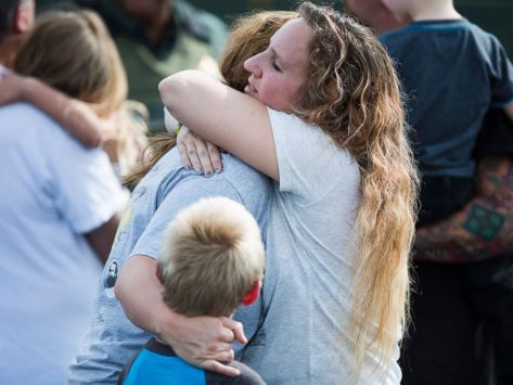 Korrie Bennett hugs Heather Bailey after recovering their children following a shooting at Townville Elementary in Townville, Sept. 28, 2016.
