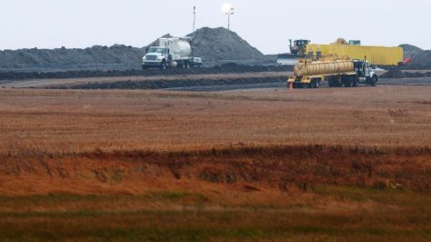FILE - This Oct. 11, 2013 file photo shows cleanup at the site of a Tesoro Corp. pipeline break that spilled more than 20,000 barrels of oil into a Tioga, N.D., wheat field. The massive oil spill still isn't fully cleaned up three years and three months after it happened. The company responsible hasn't even set a date for completion. Some say that one of the largest onshore oil spills recorded in the U.S. serves as a cautionary example, especially given a recent pipeline break about 150 miles south and ongoing debates over the four-state Dakota Access pipeline. (AP Photo/Kevin Cederstrom, File)