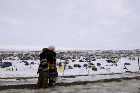Demonstrators greet each other near the entrance of the Oceti Sakowin camp as "water protectors" continue demonstrations against plans to pass the Dakota Access pipeline continue near the Standing Rock Indian Reservation, near Cannon Ball, North Dakota, U.S., December 2, 2016. REUTERS/Lucas Jackson