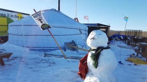 A snowman stands as the remaining activists are grappling with plunging temperatures that make conditions more difficult at the protest camp in Cannon Ball, North Dakota, December 14, 2016. Picture taken December 14, 2016. REUTERS/Valerie Volcovici