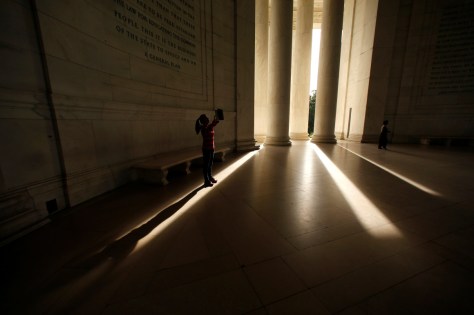 A visitor to the Jefferson Memorial casts a long shadow as she holds up her tablet to take a photo on October 12. REUTERS