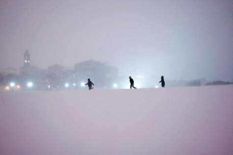 Children play in the snow on the National Mall after a snowstorm on January 23. Getty