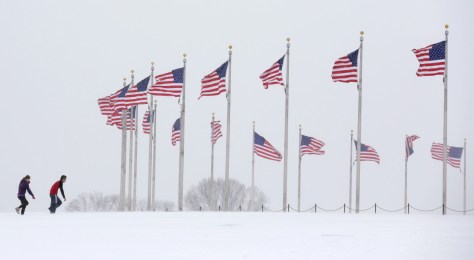 People frolic in the snow near the Washington Monument during a winter storm on January 23. A deadly blizzard blanketed the eastern United States in near-record amounts of snow, shutting down New York and Washington in a colossal storm expected to affect more than 85 million people. More than 4,400 flights were cancelled as the mega-storm brought airports in New York, Philadelphia, Washington and Baltimore to a halt, shuttered transport in the US capital and prompted New York officials to issue a sweeping travel ban. REUTERS